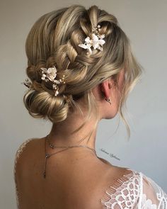 a woman with blonde hair and flowers in her hair is wearing a white dress, looking back