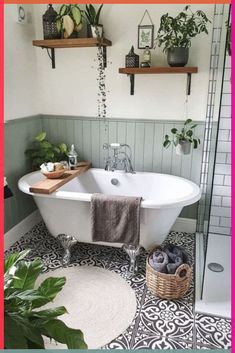 a white bath tub sitting in a bathroom next to a green plant and potted plants