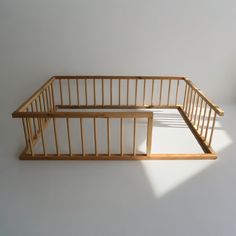 a wooden bed frame sitting on top of a white floor