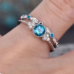 a woman's hand with a blue and white ring on top of her wrist