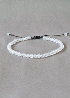 Delicate dainty selenite gemstone bracelet. Stress relief wellness healing crystal selenite - slim style beaded bracelet - natural selenite crystal - boho chic style made with black string and adjustable closure - ready to give it as a gift this dainty bracelet comes wrapped in one nice jewelry bag.  If you like this bracelet please leave a score and a few words why you like it on the review section. Thank you very much! About order: Please measure your wrist accurately then select your size fro Adjustable Moonstone Bead Jewelry, Adjustable Beaded Moonstone Bracelets With Natural Stones, Minimalist Handmade Beaded Bracelet With Moonstone, Adjustable Moonstone Bracelet With Gemstone Beads, Adjustable Moonstone Crystal Bracelet With Natural Stones, Adjustable White Crystal Bracelet With Gemstone Beads, Adjustable Moonstone Bracelets For Everyday, Handmade Minimalist Moonstone Beaded Bracelet, Handmade Minimalist Moonstone Bracelets