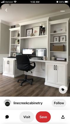 a computer desk sitting in front of a white book shelf filled with books and papers