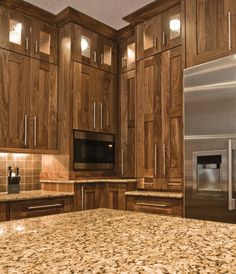 a kitchen with granite counter tops and wooden cabinets