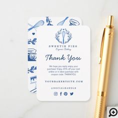 a white and blue thank card next to a gold pen