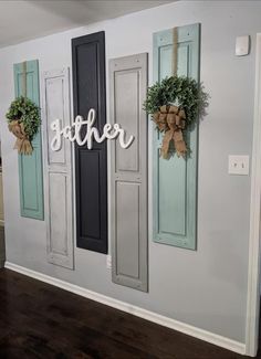 the wall is decorated with wreaths and wooden letters that spell out another word on it