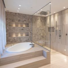 a bathroom with a large bathtub next to a walk in shower