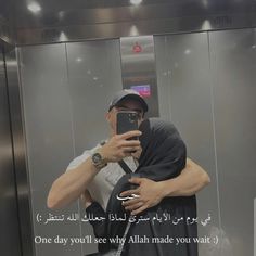 a man taking a selfie in front of an elevator with his cell phone up to his face