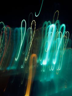 blurry photograph of street lights in the night with green and yellow streaks on them