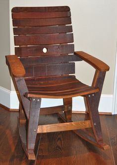 a wooden rocking chair sitting on top of a hard wood floor