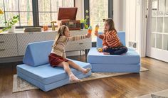 Two girls playing ice cream cone on a Bellbottom Nugget® Fun Couch, Toddler Play Area, The Nugget, Play Couch, Triangle Pillow, Activity Room, Room Seating, Toddler Play, Creative Living