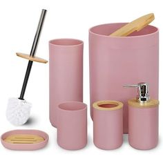 pink bathroom accessories including toothbrush holder, soap dispenser, and brush