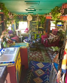 a room filled with lots of colorful rugs and furniture next to a kitchen sink