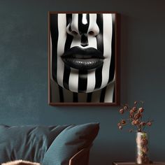 a woman's face with black and white stripes on it is framed in wood