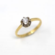 Lovely vintage circa 1960s era retro 18k yellow & white gold genuine diamond ring! This beautiful ring features a 1/5 carat brilliant cut diamond, in a belcher style white gold setting. The setting is 18k yellow gold and free of design. A timeless piece of fine retro jewelry, that would be a gorgeous engagement ring! ERA - Circa 1960s / Retro METAL / MATERIAL - 18k yellow gold & white gold, 1 round cut genuine diamond (estimated 1/5 CT., SI1 clarity, I/J color) MARKINGS / HISTORY - N/A CONDITION Retro Yellow Gold Rings Stamped 14k, Vintage Gold Diamond Ring With Brilliant Cut, Vintage Yellow Gold Diamond Ring With Diamond Cut, Vintage Yellow Gold Diamond Cut Diamond Ring, Vintage 14k Yellow Gold Diamond Ring, Vintage Yellow Gold Diamond Ring With Single Diamond, Vintage Yellow Gold Diamond Ring With Single Stone, Vintage Diamond White Cluster Ring With Diamond Cut, Vintage Diamond White Diamond Ring For Formal Occasions