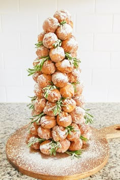 a christmas tree made out of doughnuts and sprinkled with rosemary