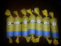 six yellow and blue wrapped candy bags with minion faces drawn on them, all lined up in a row