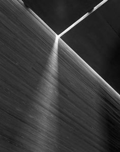 a skateboarder is doing a trick in the air with his board and shadow on the ground