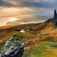 the mountains are covered in grass and rocks