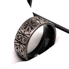 Exchange vows on your wedding day with this exclusive Black Plated Tungsten Ring with Viking Symbols Engraved Around the Ring. The symbols can be customized based on whatever you may like, please contact us to get a quote. The ring measures 8mm in width and is available from sizes 5 to 15. If you would like a matching ring in 6mm, please contact us. The ring is designed with a comfort fit interior. - Width - 8mm - Material - Tungsten Carbide - Color - Black, Silver - Sizes - 5 to 15 - Finish- Hi Symbolic Black Wedding Jewelry, Symbolic Black Jewelry For Wedding, Black Symbolic Jewelry For Promise, Black Engraved Wedding Ring, Symbolic Black Engraved Ring As Gift, Black Engraved Ring For Promise, Symbolic Black Engraved Ring For Anniversary, Men Viking Wedding Rings, Symbolic Black Engraved Ring For Gift