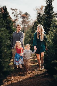 a family walking through a christmas tree farm