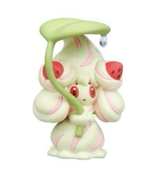 a small figurine that is sitting on top of a white surface with pink and green accents