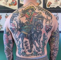 the back of a man with tattoos on his body