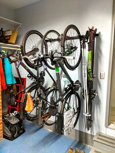 there is a bike hanging on the wall next to some skis and snowboards