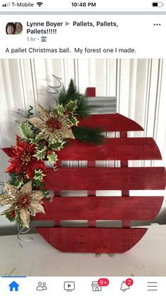 a wooden christmas ornament with poinsettis and greenery on it