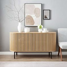 a living room with grey walls and wooden furniture