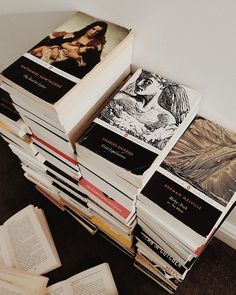 a stack of books sitting on top of a carpeted floor