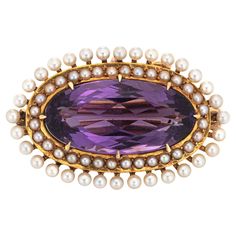 Finely detailed antique Victorian amethyst & seed pearl pendant/brooch (circa 1880s to 1900s), crafted in 14 karat yellow gold by Krementz. Oval faceted amethyst measures 21mm x 11mm (estimated at 9 carats). 64 seed pearls graduated in size from 1.5mm to 2mm. The piece is made by Krementz, a renowned Newark, NJ maker of fine jewelry. The versatile piece can be worn as a brooch or pendant (the pendant sits in an east-west position). The rich royal purple amethyst is framed with a double row of se Vintage Pendant Necklace, Yellow Gold Jewelry, Amethyst Jewelry, Seed Pearl, Antique Victorian, Purple Amethyst, Pearl Pendant, Jewelry Art, Antique Jewelry