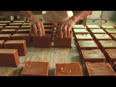 a person placing chocolate squares on top of each other