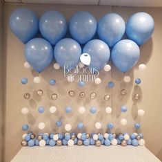 blue and white balloons are on the wall