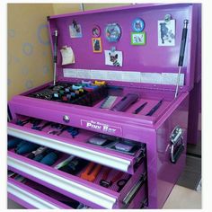 a purple dresser with lots of drawers in it