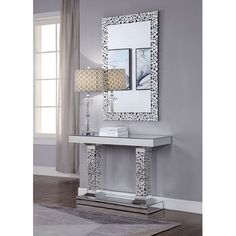 a white table with a mirror and lamp on it