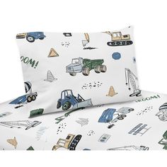 a white bed with blue and green construction vehicles printed on the sheet set, along with matching pillow cases