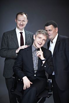 three men in suits and ties posing for the camera with their hands on their chins