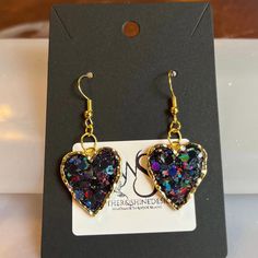 Step into a world of enchantment with our Sparkling Dreams earrings, featuring charming hearts adorned with dazzling glitter in various colors. Each pair is a celebration of individuality, allowing you to express your style with a burst of color and sparkle. Handcrafted with precision, these earrings are versatile enough to complement both casual and formal looks. Key Features: *Handcrafted heart earrings with a variety of glitter colors *Lightweight and comfortable for extended wear *Secure earring backs for a worry-free experience *Unique and eye-catching design for a statement look Materials: These earrings are crafted using high-quality materials, with each heart showcasing a different glitter color. Choose the shade that resonates with your mood or outfit, and let your personality shi Glamorous Double Heart Jewelry Gift, Glamorous Double Heart Jewelry As Gift, Heart Cut Earrings With Heart Charm For Party, Glamorous Sparkling Earrings As Gift, Glamorous Sparkling Earrings For Gift, Heart Shaped Pierced Jewelry For Party, Elegant Glitter Dangle Jewelry, Valentine's Day Heart Cut Earrings For Party, Double Heart Charm Earrings For Party