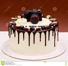 a cake decorated with chocolate icing and candies is on a plate, ready to be eaten