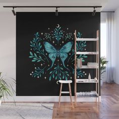 a blue butterfly with stars and leaves on a black background wall mural in a living room