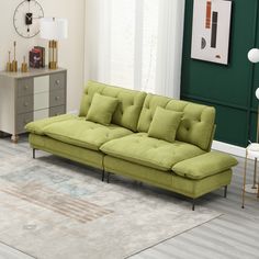 a living room with a green couch and white rug