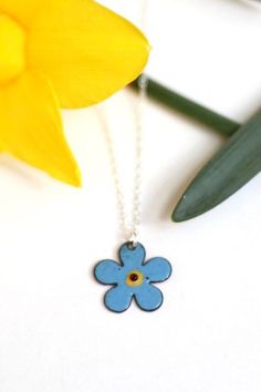 Pretty forget-me-not flower pendant in soft pastel blue enamel with central glass bead. * Flower measures 24mm * Copper is backed with enamel to provide comfort and strength  * Complete with a 925 sterling silver chain * Boxed in an iamrachel branded black box ready for gifting * Each order will vary slightly due to the qualities of enamel  This flower necklace is a beautiful piece of nature jewelry and would make a lovely sentimental gift for a gardener or flower lover. CUSTOMISE: Please contac Flower Charm Enamel Necklace, Floral Enamel Necklace With Flower Charm, Enamel Flower Charm Necklace, Blue Flower Pendant Necklace Nickel Free, Blue Flower Shaped Necklace Gift, Blue Nickel-free Flower Pendant Necklace, Blue Flower Charm Necklace As Gift, Blue Flower Necklace For Gifts, Light Blue Flower-shaped Jewelry For Gifts