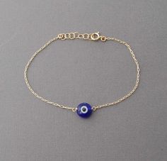 Evil eye on a delicate 14k gold fill, 14k rose gold fill, or sterling silver chain. You can choose from a light blue, dark blue, red, white, or clear eye. The eye measures approx 1/4th of an inch. If you need a specific size, please let me know. I can do any length you want. Comes packaged in a jewelry box. Blue Evil Eye Bracelet, Diy Wire Jewelry Rings, Jewelry Necklace Simple, Wire Jewelry Rings, Eye Bracelets, Rose Gold And Silver, Brown Jewelry, Jewelry Fashion Trends, Classy Jewelry