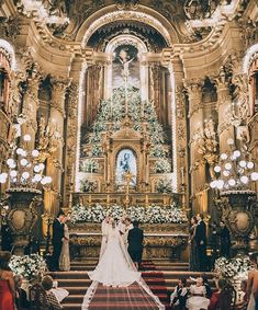 the bride and groom are standing in front of the alter