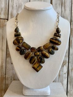 Tiger Eye is mesmerizing with its shimmering bands of yellow-brown to golden color -21 inch necklace with 2 1/2 inch drop -.925 overlay sterling silver -adjustable length with toggle closure   Originally $258. On limited time SALE Luxury Brown Jewelry With Natural Stones, Adjustable Brown Sterling Silver Necklaces, Adjustable Brown Sterling Silver Necklace, Elegant Brown Necklace With Polished Finish, Elegant Brown Jewelry With Stones, Unique Brown Jewelry With Adjustable Chain, Brown Jewelry With Adjustable Chain For Jewelry Making, Artisan Brown Sterling Silver Necklace, Luxury Handmade Brown Necklaces