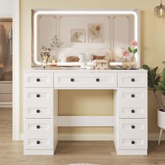 a white desk with drawers and a mirror above it