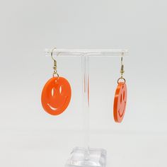 This cute pair of earrings is perfect for the 90 fan. The adorable orange smiley face charms show off your fun y2k style. They feature bright orange smiley face designs Hard acrylic provides ‌protection‌ ‌and‌ ‌durability Nickle free and hypoallergenic hooks Orange Smiley Face, Charmed Show, Stationary Shop, Stay Happy, Acrylic Charms, New Sticker, Face Design, Sticker Shop, Smiley Face