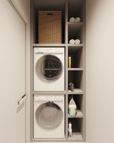 a washer and dryer in a small room with shelves on the wall behind them