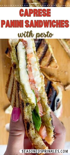 a person holding up a sandwich in front of the camera with text that reads, caprese panini sandwiches with pesto