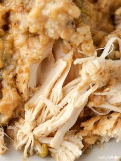 closeup of shredded chicken and vegetables on a white plate with text overlay that reads, how to make shredded chicken